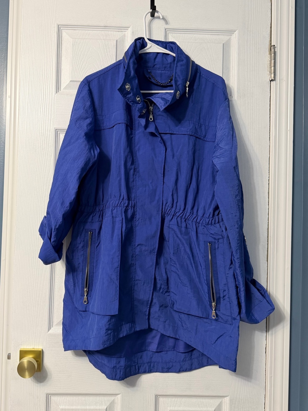 Purple blue raincoat with hood that zips into the collar. Tags removed. Size xl